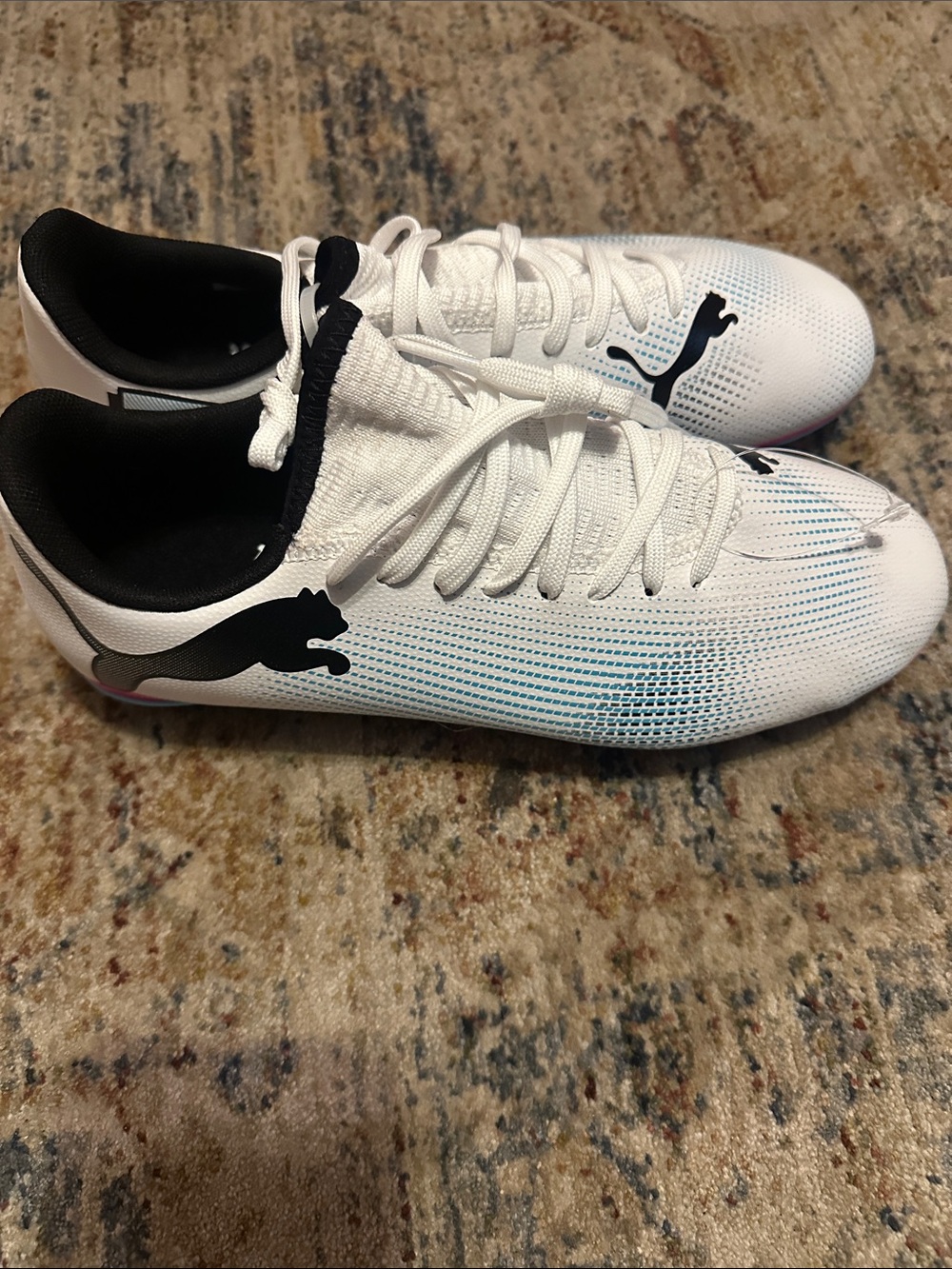 Puma White Black Low-Profile Athletic Cleats with Subtle Blue Tint